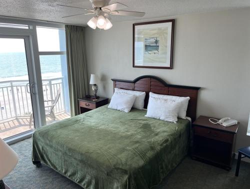 a bedroom with a bed with a view of the ocean at Spacious 2 bedroom Direct Ocean Front Condo, Corner Unit, Balconies HSS 5th FL in Myrtle Beach