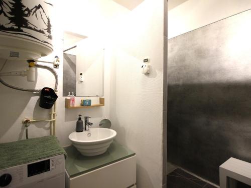 a small bathroom with a sink and a shower at Studio 26m² au centre de La Bourboule avec WIFI, proche des Thermes - FR-1-415-157 in La Bourboule
