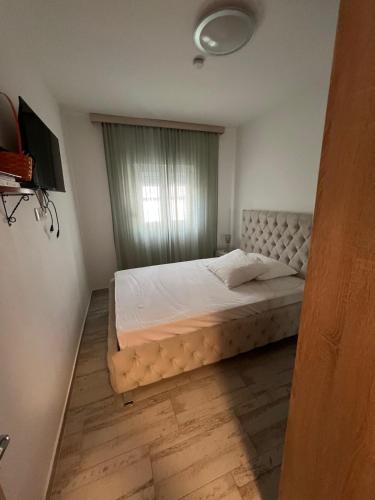 a bedroom with a large bed with a window at Smart Bijela in Bijela