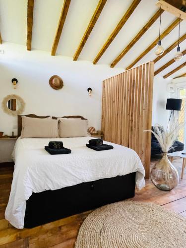 une chambre avec un grand lit avec des draps blancs dans l'établissement Gîte en Pays Basque Les Chênes Avec jacuzzi, à Came