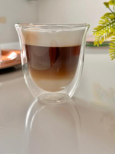 a glass cup of coffee sitting on a table at Calatabarca B&B in Tabarca