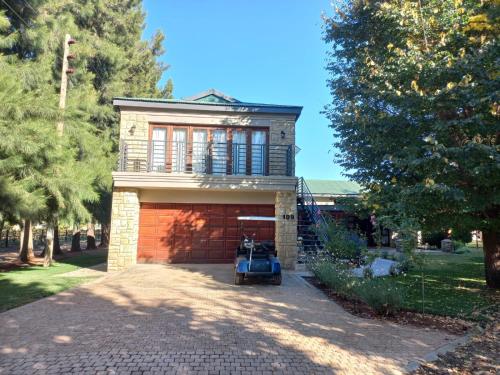 a house with a car parked in front of a garage at 109 Mauser Avenue in Pretoria