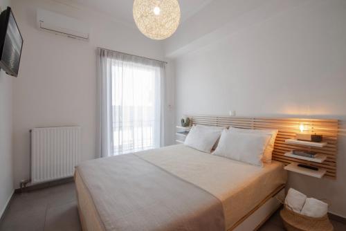 a bedroom with a large bed and a window at Georgia's House in Galatas