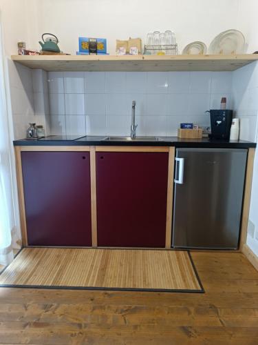 a kitchen with a sink and a refrigerator at SUITTINA, exclusive - wellness - living in Battipaglia