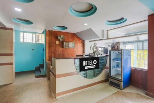 a kitchen with a counter with a mitzo sign on it at Hotel O Nellore Subbareddy Government Hospital Hotel Rama Royal in Nellore