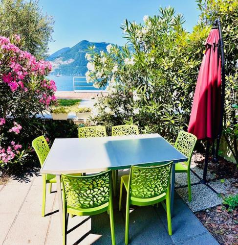 a table and chairs and an umbrella on a patio at Dock House in Marone