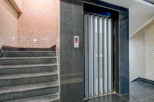 a staircase in a building with a stair case at Hotel O Tamando Jagannath Temple Hotel Blue Royal in Bhubaneshwar