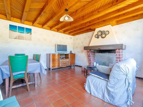 a living room with a table and a fireplace at Maison 6 pers à Vielle-Saint-Girons - Jardin et parking - FR-1-50-186 in Vielle-Saint-Girons