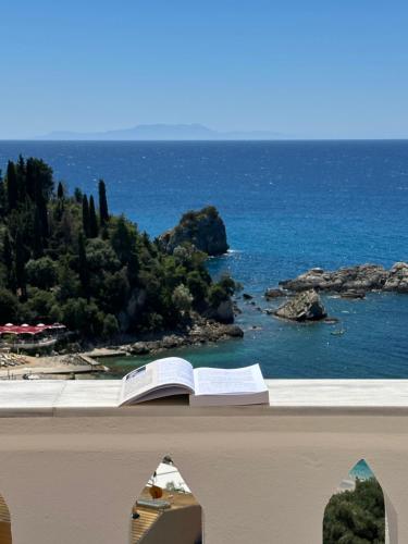 an open book on a ledge overlooking the ocean at Sea Bliss Adults Only in Parga