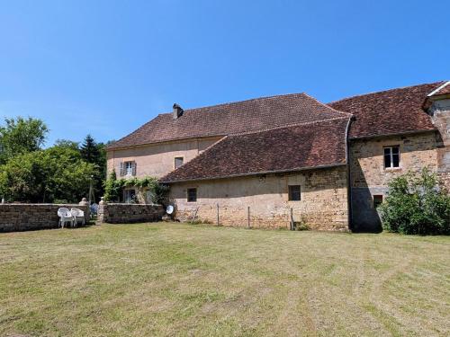 an old stone house with a yard in front of it at Gîte paisible près des forêts - FR-1-583-504 in Montigny-les Cherlieux