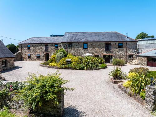 an external view of a stone house with a courtyard at Callestock Courtyard Cottages in Truro