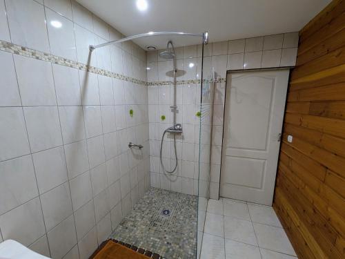 a shower with a glass door in a bathroom at Gîte paisible dans forêts avec vélos et randonnées, animaux admis - FR-1-583-503 in Montigny-les Cherlieux