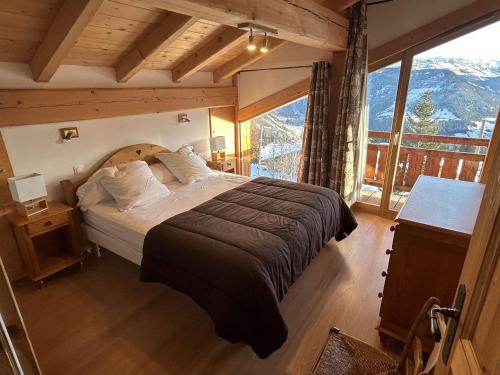 a bedroom with a bed and a large window at Chalet individuel Les Saisies pour 12 pers., superbe vue Mont Blanc - FR-1-594-334 in Hauteluce