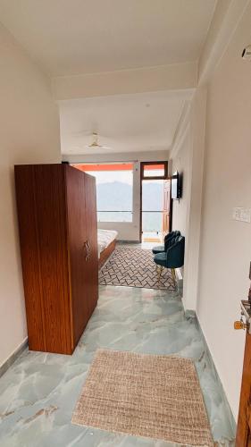 a room with a door to a bedroom with a window at Rana Homestay in Chakrāta