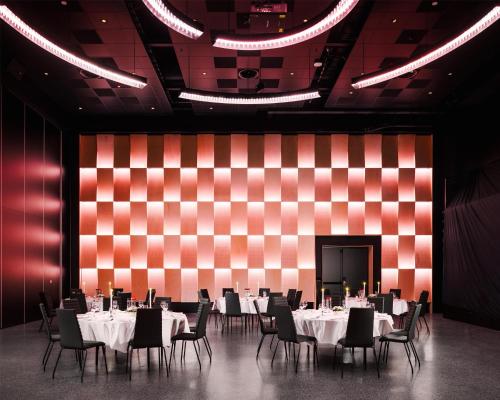 a dining room with tables and chairs and a red and white wall at Scandic Sunnfjord Hotel & Spa in Førde