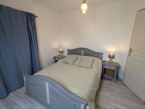 a bedroom with a bed with two night stands and two lamps at Deux gîtes charmants près d'Orléans avec jardin et parking privatif - FR-1-590-577 