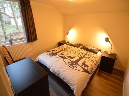 a bedroom with a bed and a window at Completely detached bungalow in a nature-filled park by a large fen in Stramproy