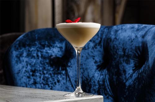 a drink in a martini glass sitting on a table at Radisson Blu Pune Hinjawadi in Pune