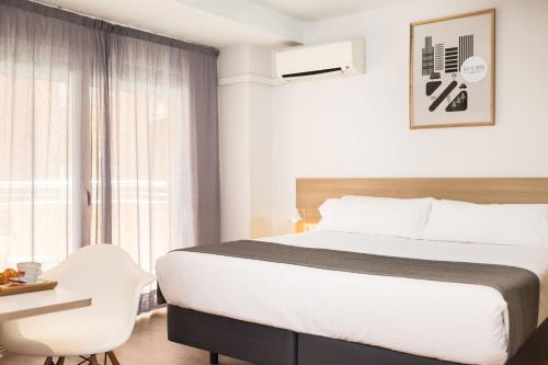 Letto o letti in una camera di Rooms Ciencias