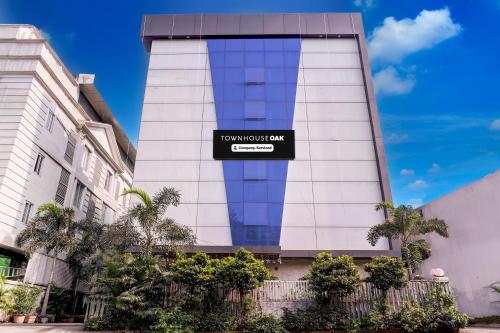 a building with a sign on the side of it at Super Townhouse OAK Kopar Khairane Navi Mumbai Formerly IVY Hotel in Navi Mumbai