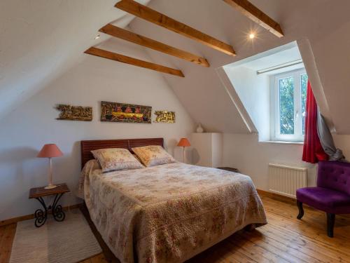 a bedroom with a large bed and a purple chair at Chambres d'Hôte Air Marin in Lannion
