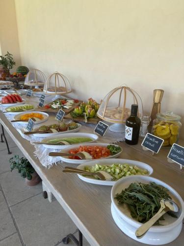 a table with many plates of food on it at Masseria Casina Fiocca in Pisignano
