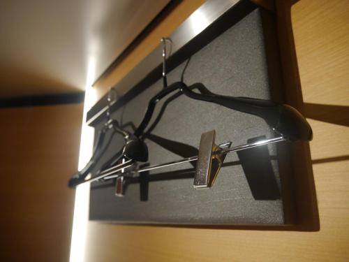 a light hanging from a wall in a room at MyCUBE by MYSTAYS Asakusa Kuramae in Tokyo