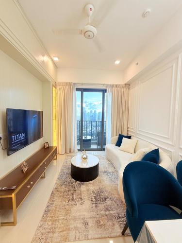 a living room with a couch and a tv at Chevalra Luxury TRI-ZEN Apartment in Central Colombo - Galle-Face & Lotus Tower View in Colombo