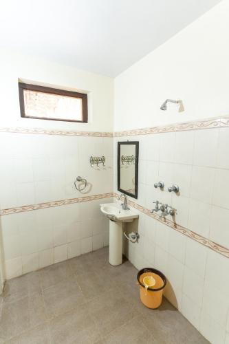 a bathroom with a sink and a mirror at Kanhaia Haveli in Pushkar