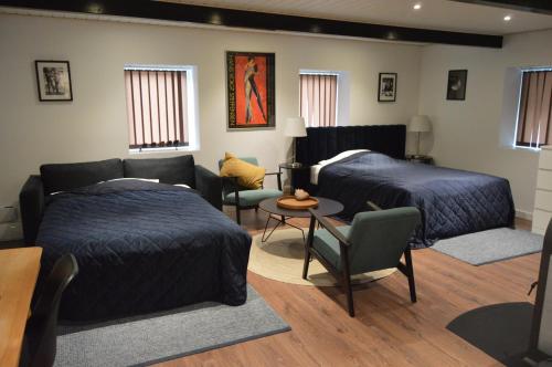 a living room with two beds and a couch at Serengeti & Stayover in Svebølle