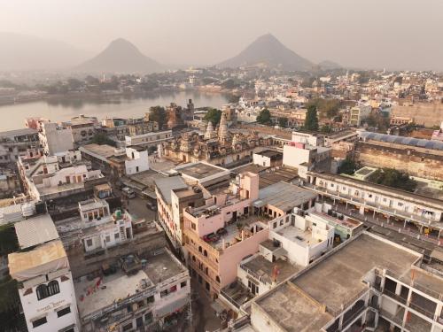 an aerial view of a city with a river and buildings at Kanhaia Haveli in Pushkar