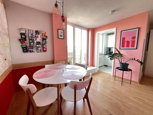a dining room with a white table and chairs at COOLEST Apartment in Berlin, easy Check-in, near BER Airport - Quiet&Cozy Penthouse in Schönefeld