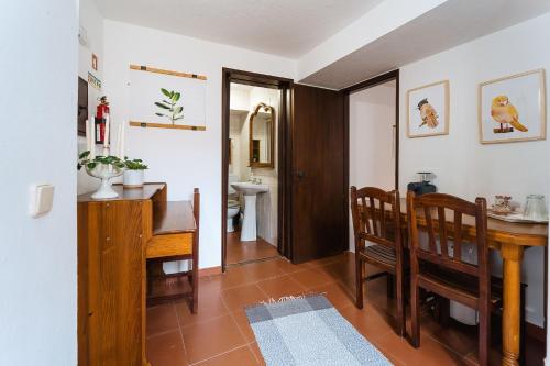 a kitchen and dining room with a table and chairs at Óbidos Priest Room in Óbidos
