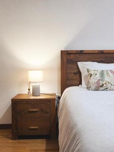a bedroom with a bed and a nightstand with a lamp at Villarmo cais in Viana do Castelo