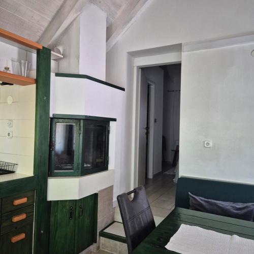 a room with a tv and a table and a chair at Romantic apartments in Šibenik