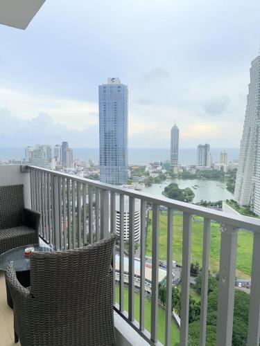 a balcony with a view of a river and buildings at Chevalra Luxury TRI-ZEN Apartment in Central Colombo - Galle-Face & Lotus Tower View in Colombo