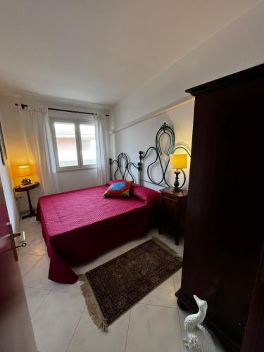 a bedroom with a red bed and a window at Levantea Liv'In Italy in Marsala