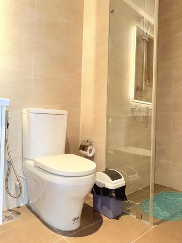 a bathroom with a toilet and a shower at Chevalra Luxury TRI-ZEN Apartment in Central Colombo - Galle-Face & Lotus Tower View in Colombo