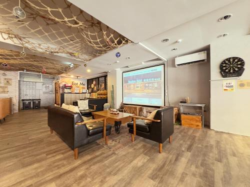 a living room with a large screen in the ceiling at Roaders Hotel Hualien Dongda in Hualien City