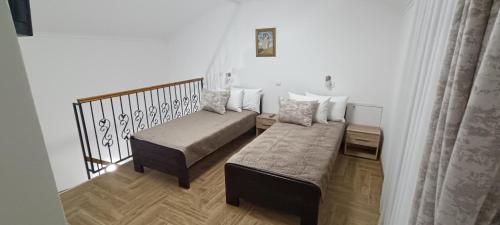 a small room with a bed and a couch at Petrovaradinski Dvor in Petrovaradin