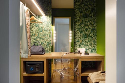 a dressing room with a desk and a mirror at Astoria Resort in Riva del Garda