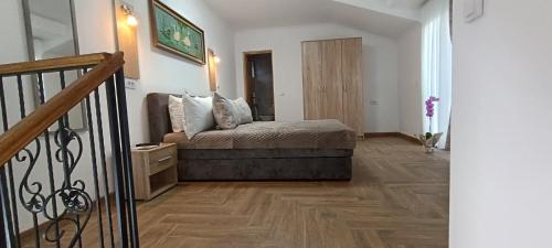 a bedroom with a bed and a wooden floor at Petrovaradinski Dvor in Petrovaradin