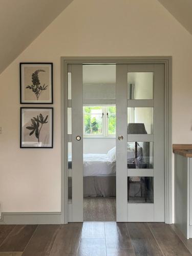 チッペナムにあるCharming one bedroomed pied a terre in rural locationsのベッドルーム1室(ベッド1台、窓付)