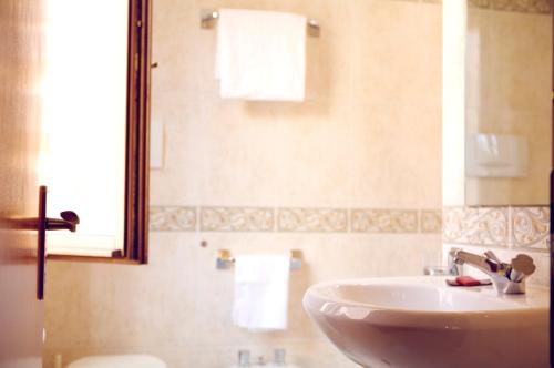 a bathroom with a white sink and a mirror at Hotel Serenissima in Venice