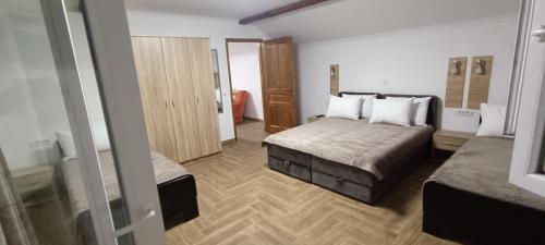 a hotel room with two beds and a mirror at Petrovaradinski Dvor in Petrovaradin