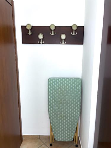 a chair sitting under a counter with a shelf at Malpensa Retreat in Ferno