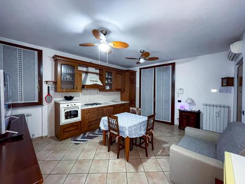 a kitchen and dining room with a table and a couch at Malpensa Retreat in Ferno