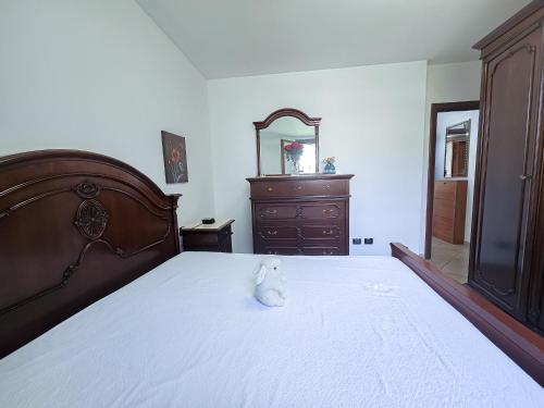 a teddy bear sitting on a bed in a bedroom at Malpensa Retreat in Ferno