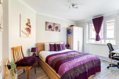 a bedroom with a bed and a table and chairs at Ultra Luxury London w Kensington balcony condo in London