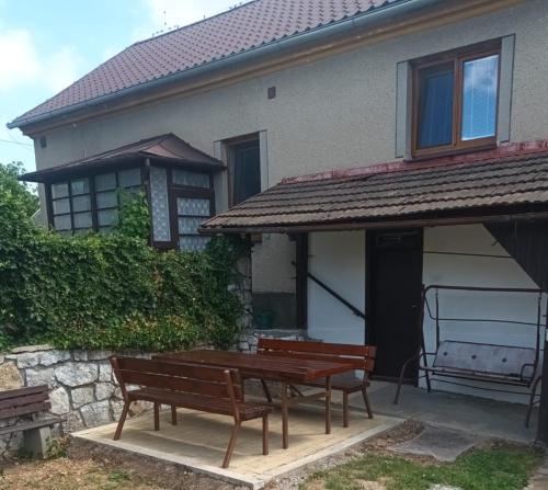 two benches sitting in front of a house at Chalupa Podolí u Bouzova in Bouzov